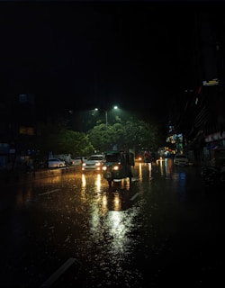 A night view of a cab driving through illuminated streets of a major Indian city.