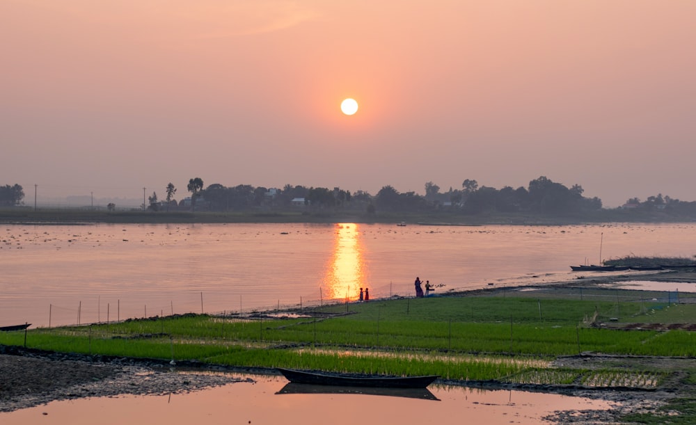 the sun is setting over a body of water