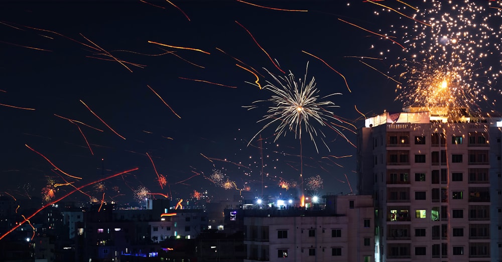 fireworks are lit up in the night sky above a city