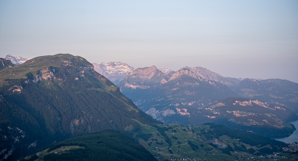 a view of a mountain range with a lake in the foreground