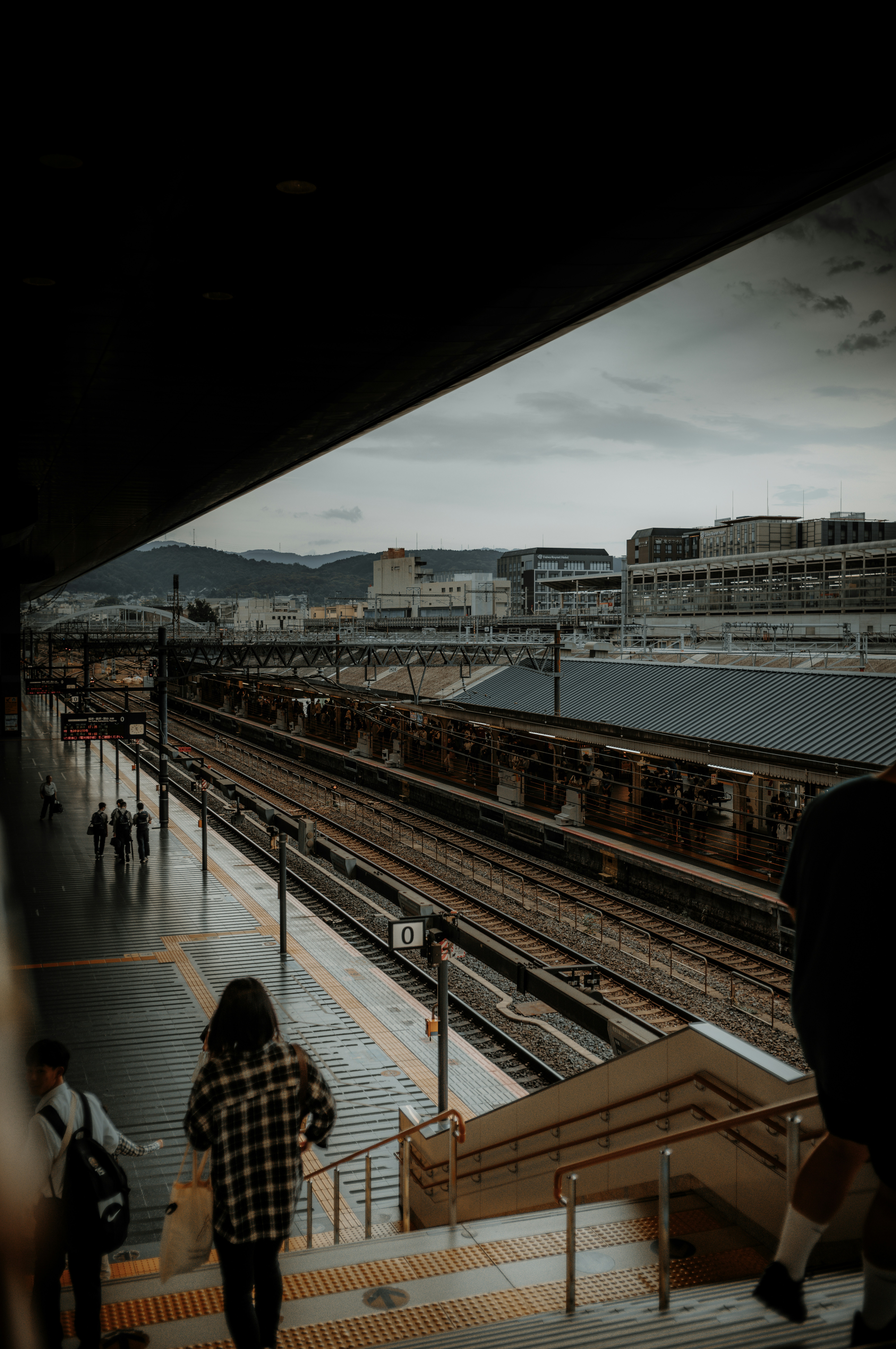 eine gruppe von menschen, die einen bahnsteig hinuntergehen