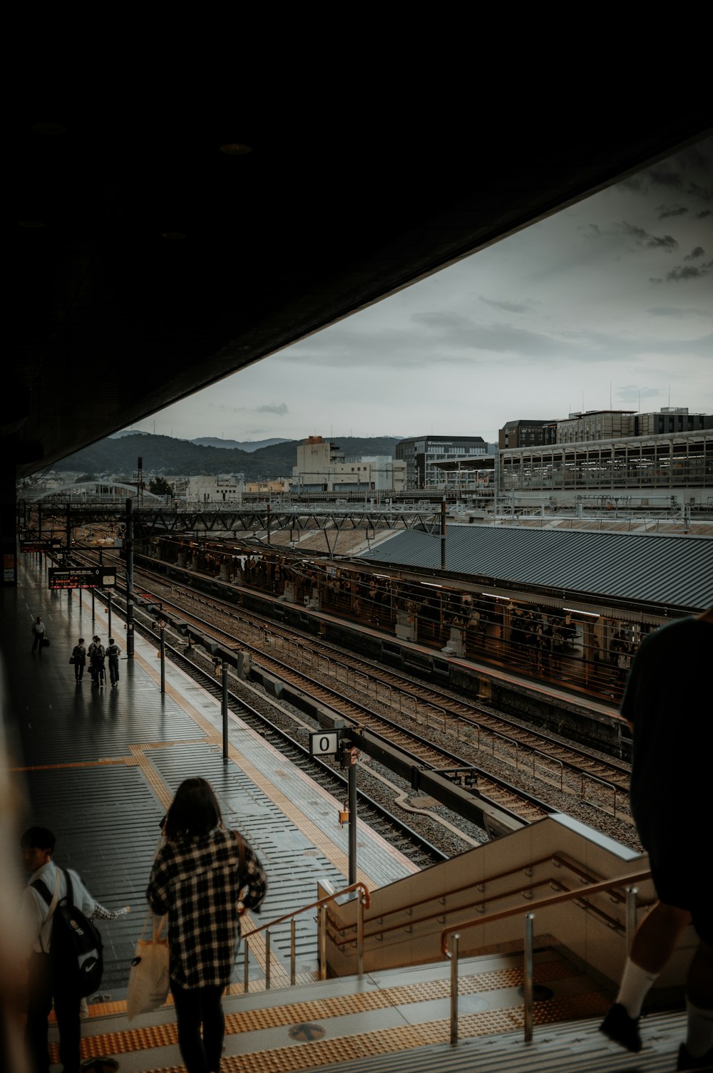 a group of people walking down a train platform