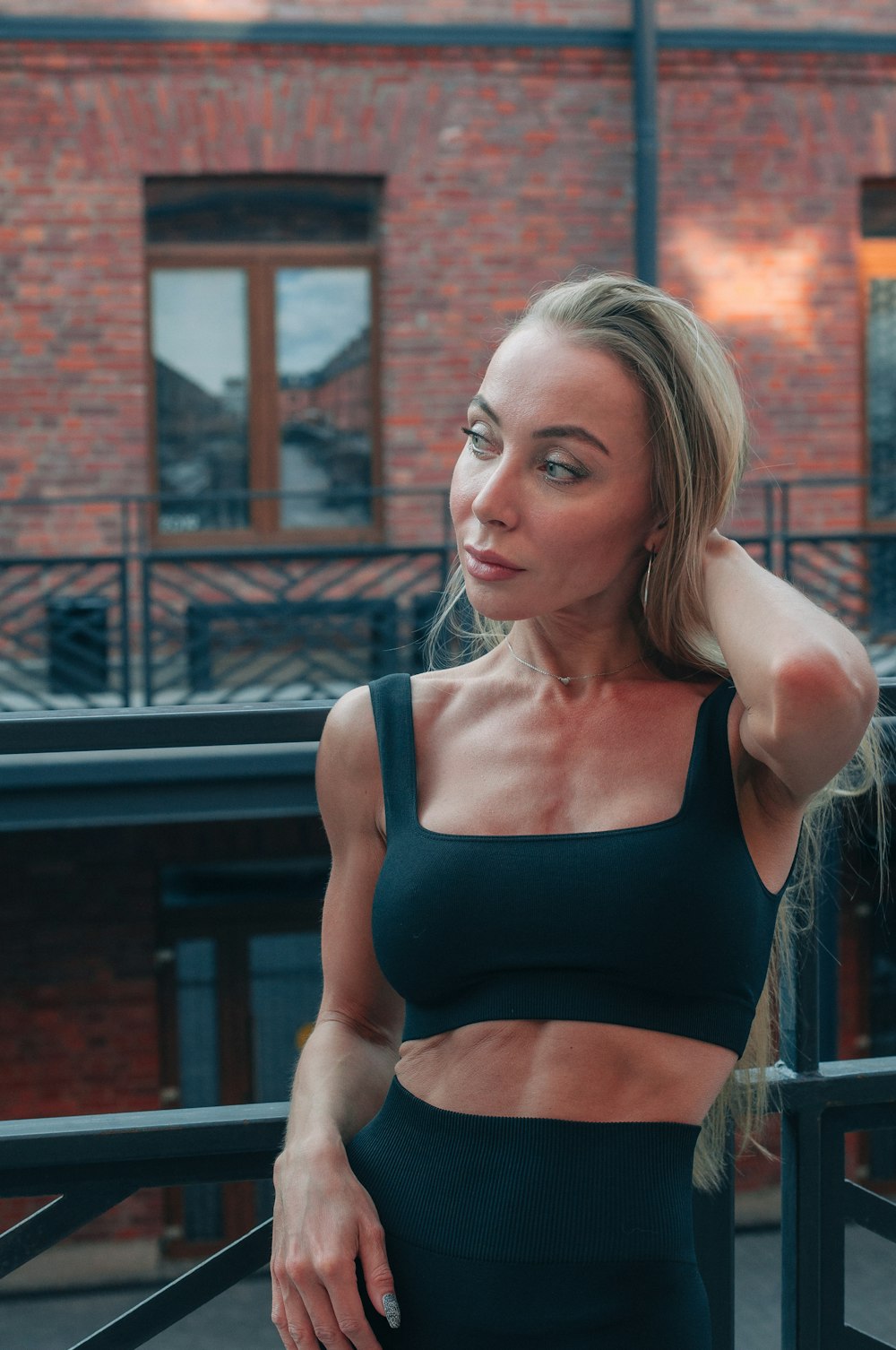 a woman in a black sports bra top posing for a picture