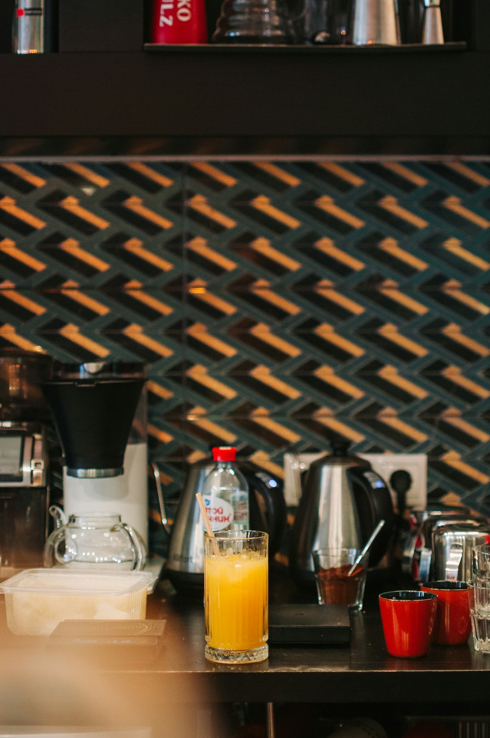 a counter with a glass of orange juice