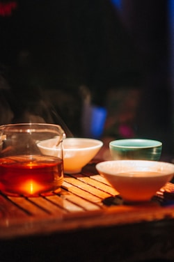 Cozy tea house interior with warm lighting and fresh juice glasses on the table