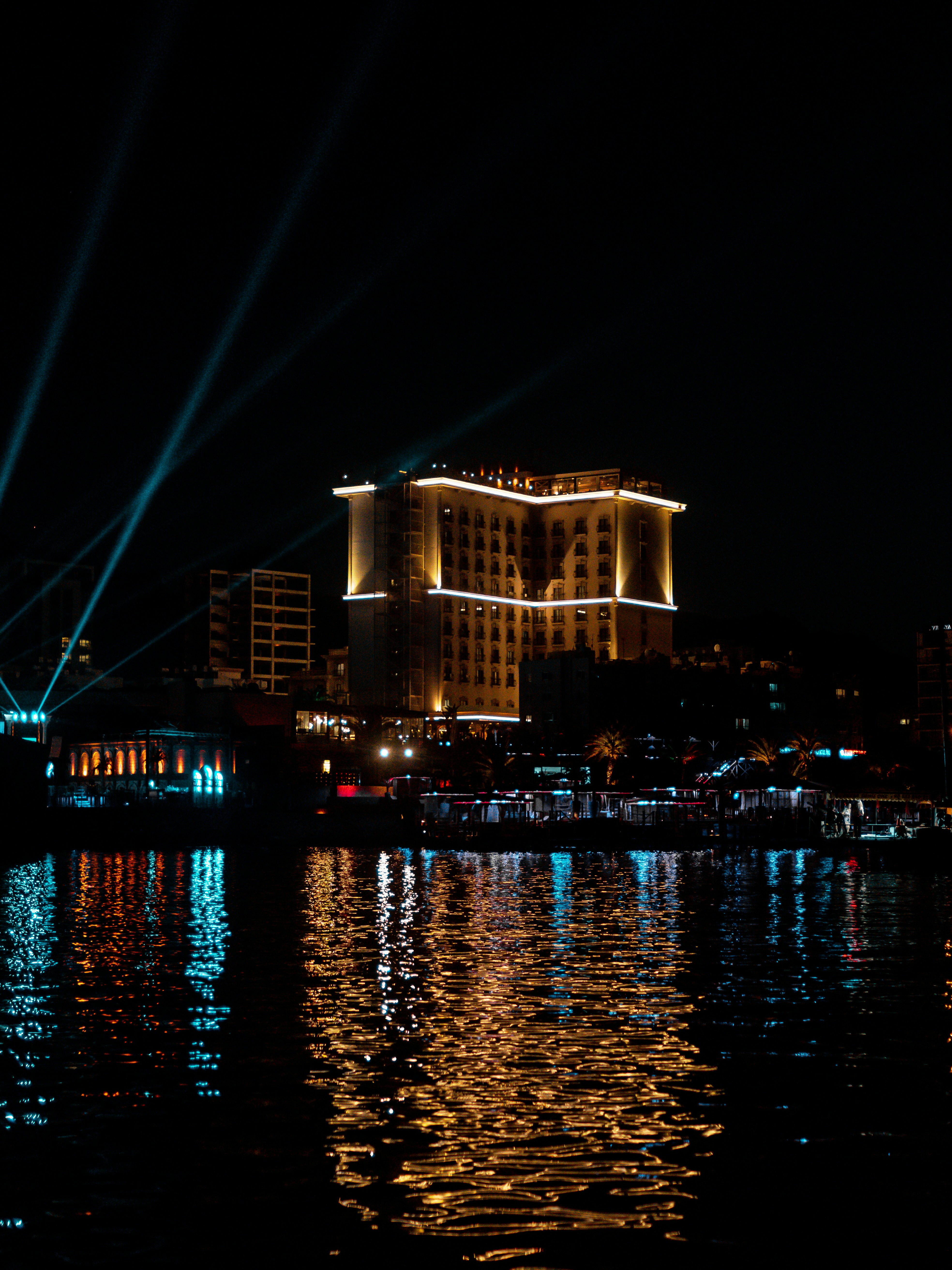 a night scene with lights reflecting in the water