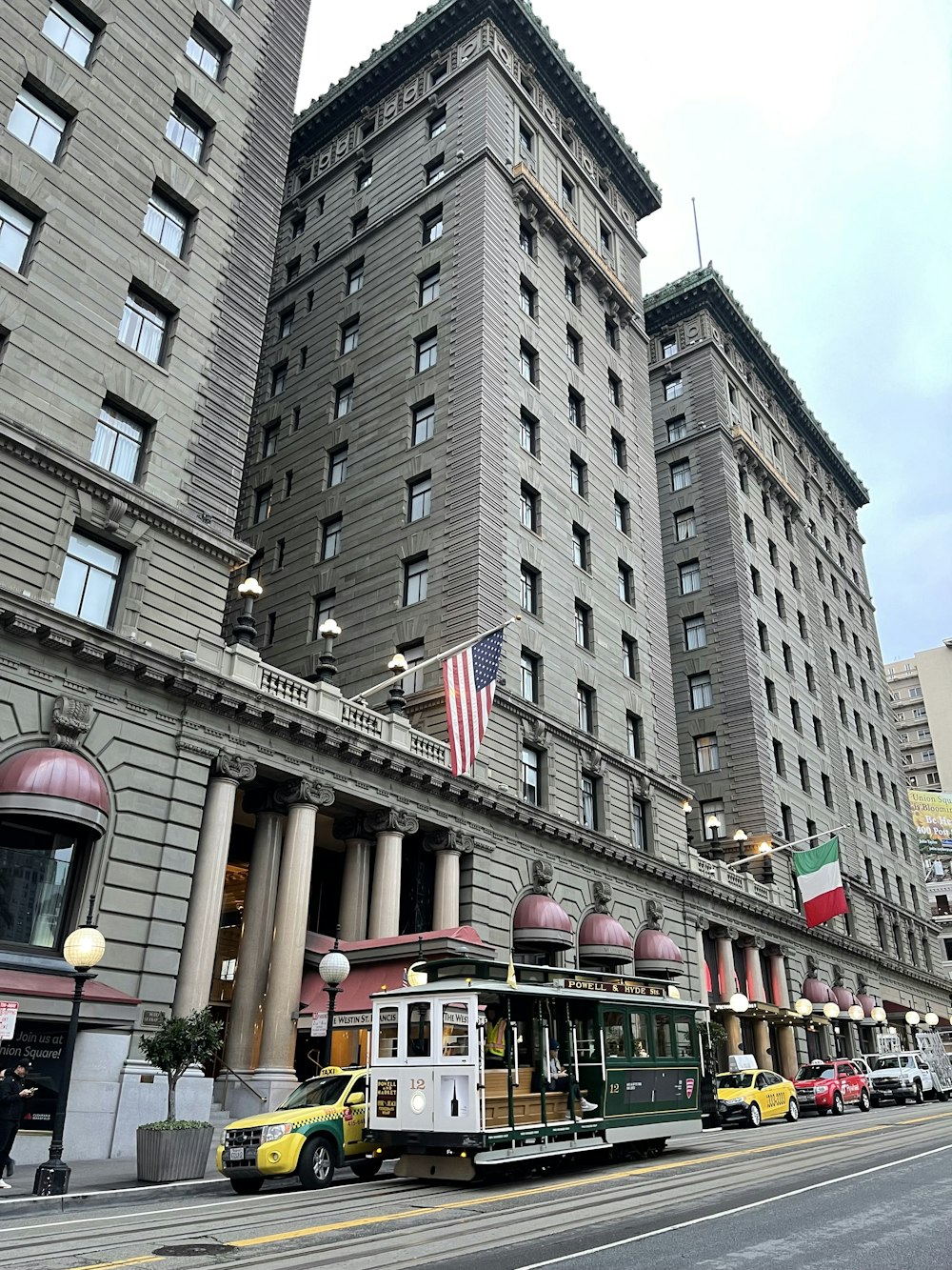 a trolley on a street in front of a large building