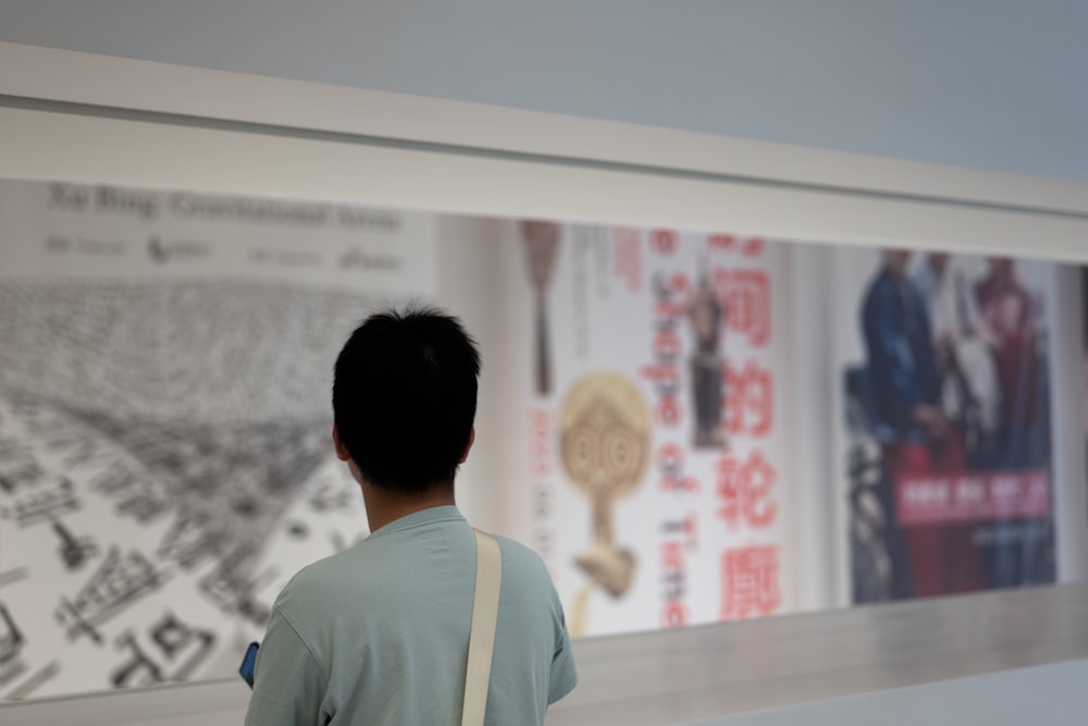 a boy looking at a picture of a city