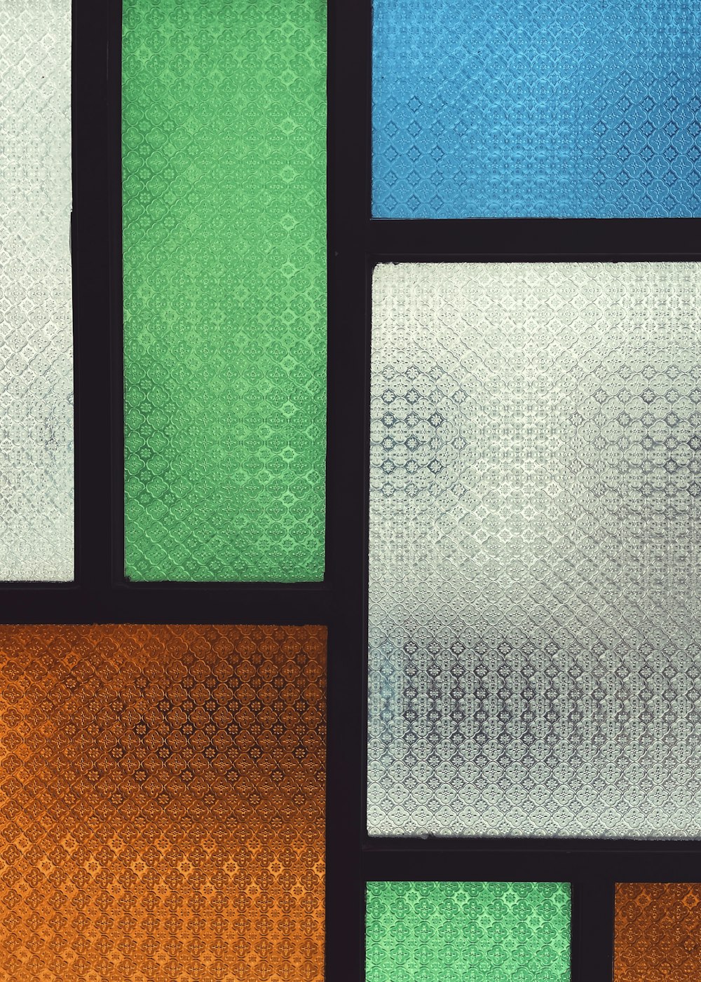 a close up of a glass window with different colors