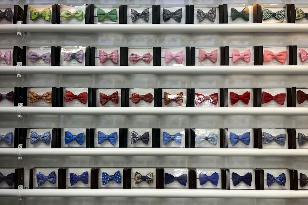 a display of many different colored bow ties