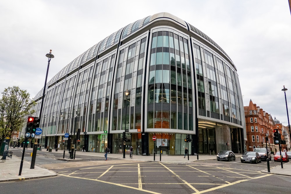 a large glass building sitting on the corner of a street