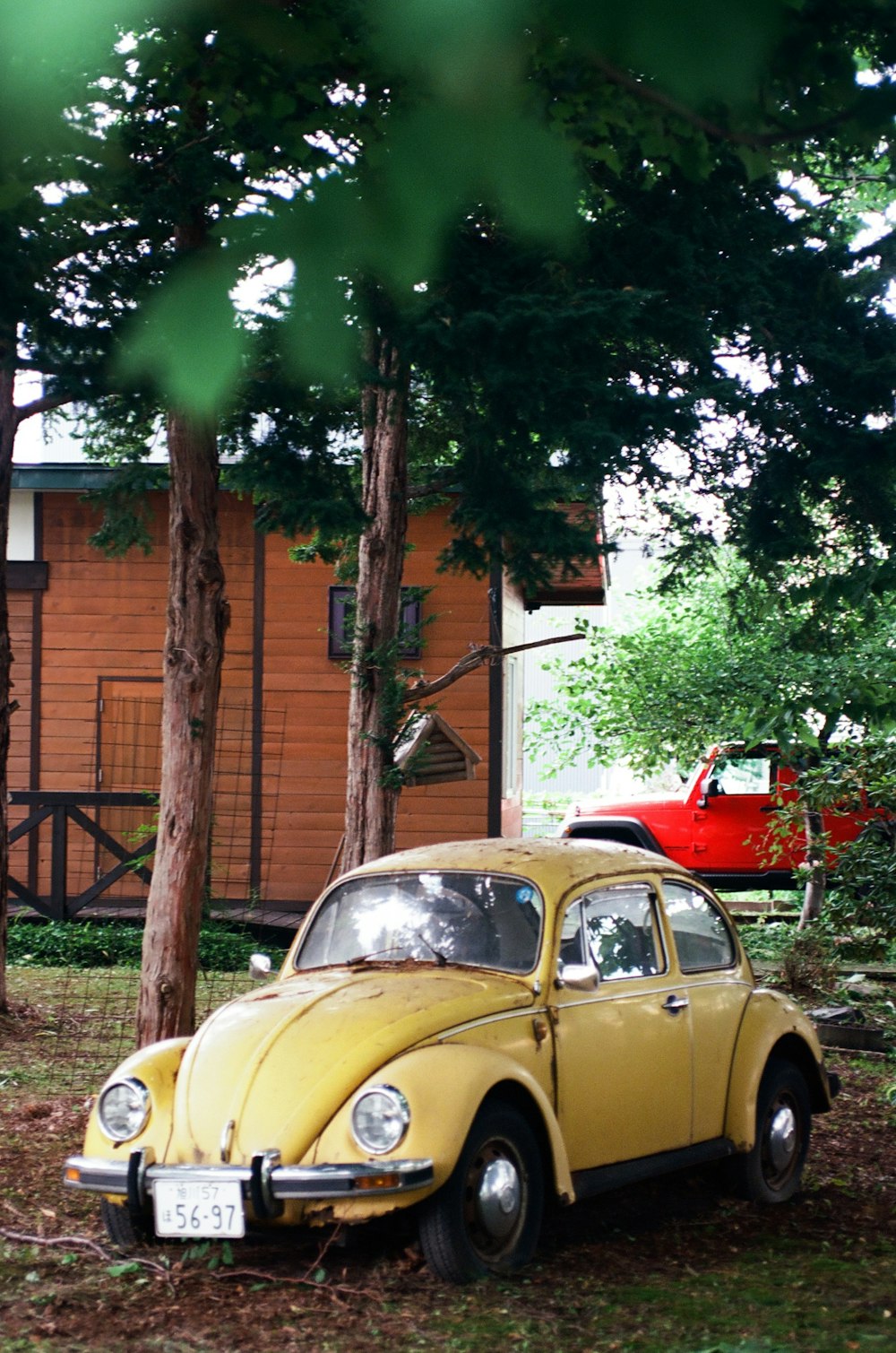 a yellow car parked in front of a house