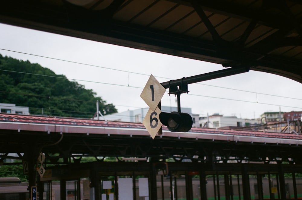 a traffic light hanging from the side of a bridge