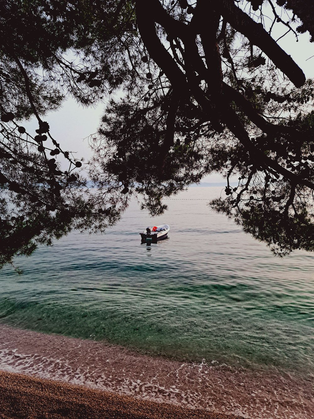 a small boat floating on top of a body of water