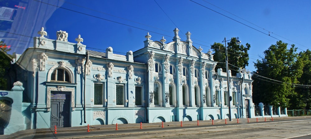 a large blue building sitting on the side of a road
