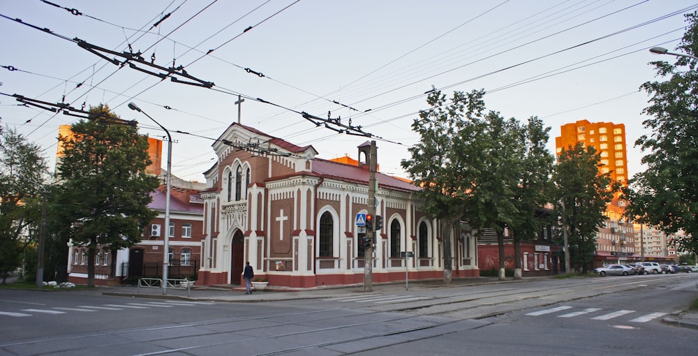 a red and white building sitting on the side of a road