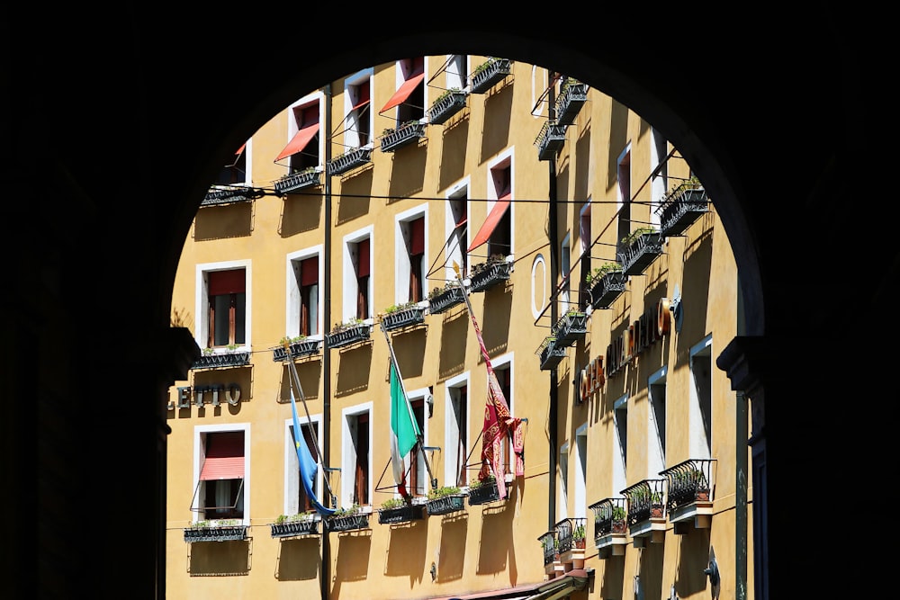 a yellow building with many windows and balconies