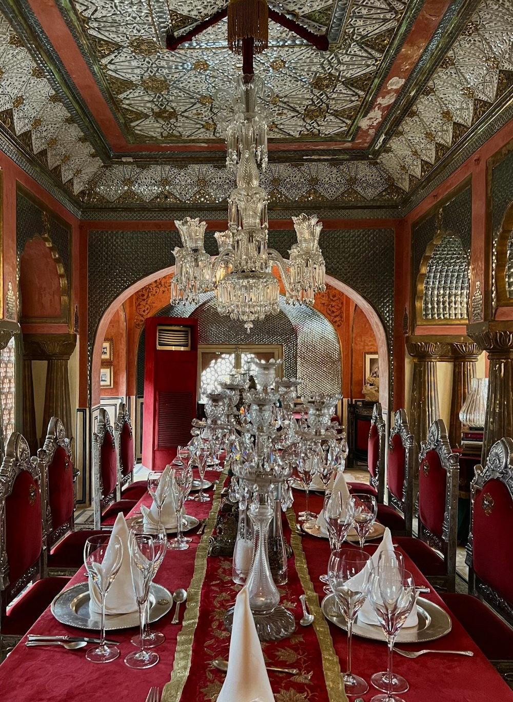 a fancy dining room with a chandelier hanging from the ceiling