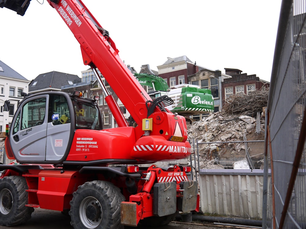 a red crane is parked on the side of the road