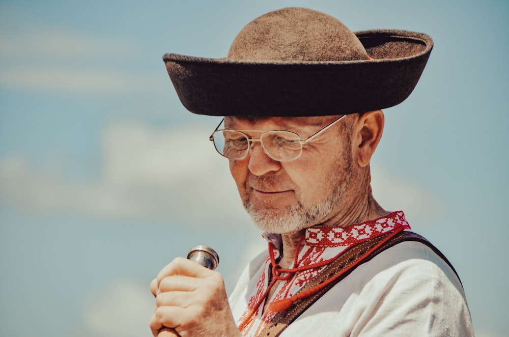 a man wearing a hat and holding a microphone