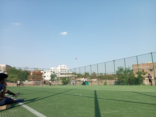 A group of students practicing soccer drills on a sunny outdoor field.