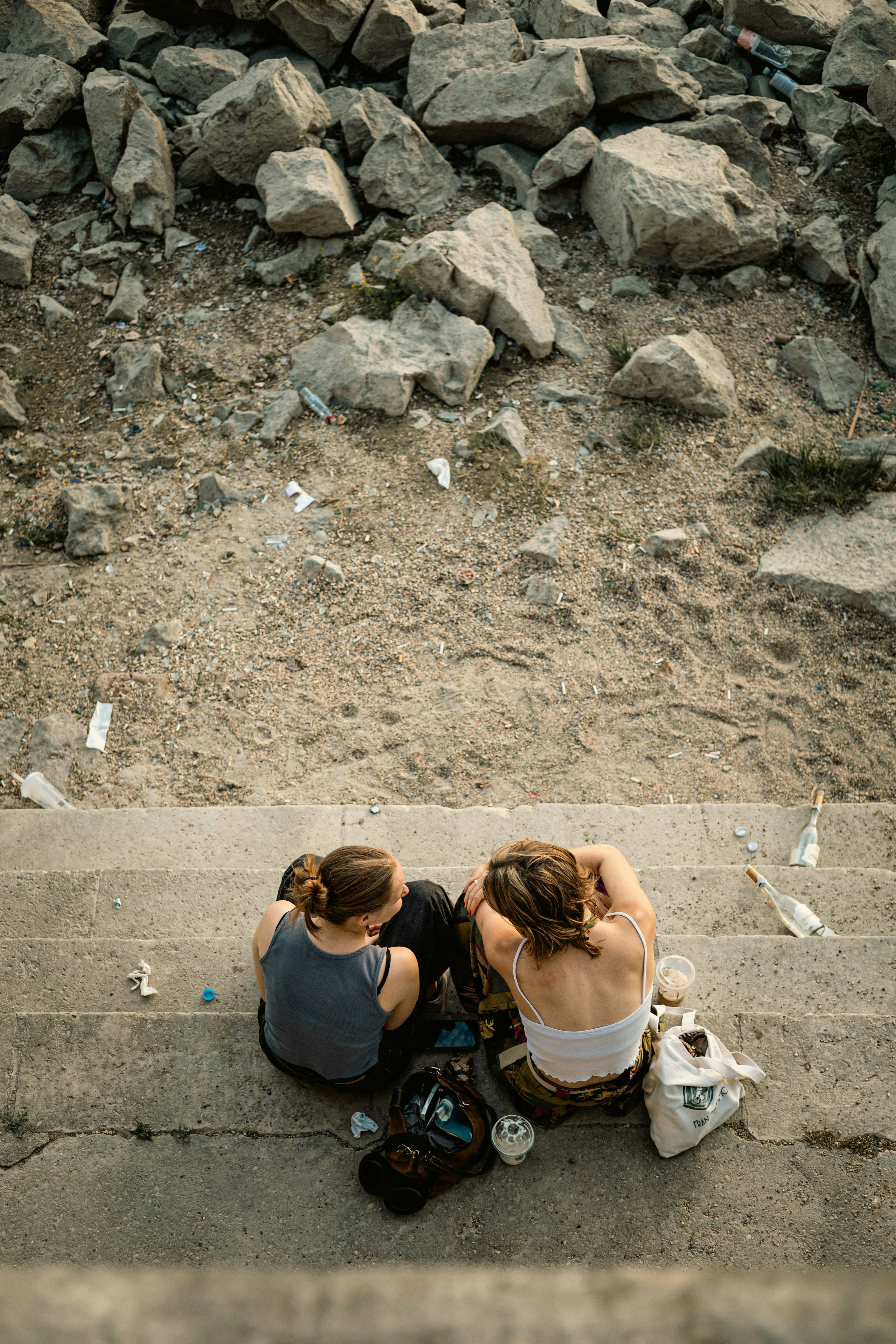 a couple of people sitting on top of a cement step