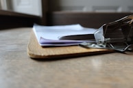 Close-up of hands checking inventory on a clipboard.