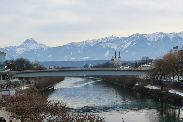 A bridge over a river with mountains in the background — Zell am See, Austria
