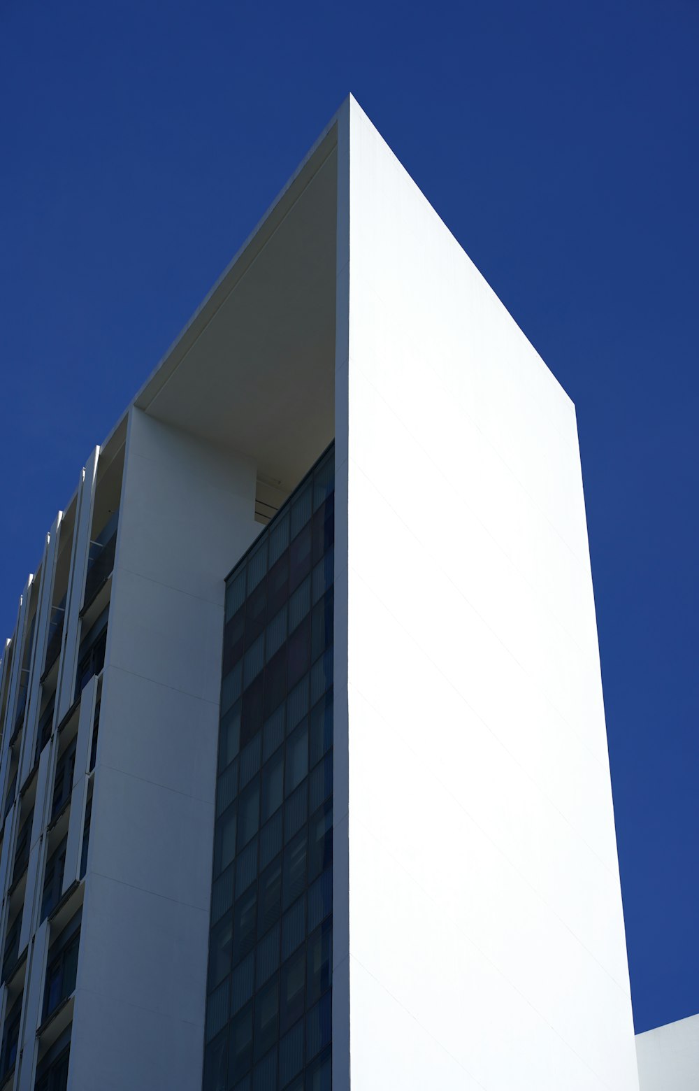 a tall white building with a blue sky in the background