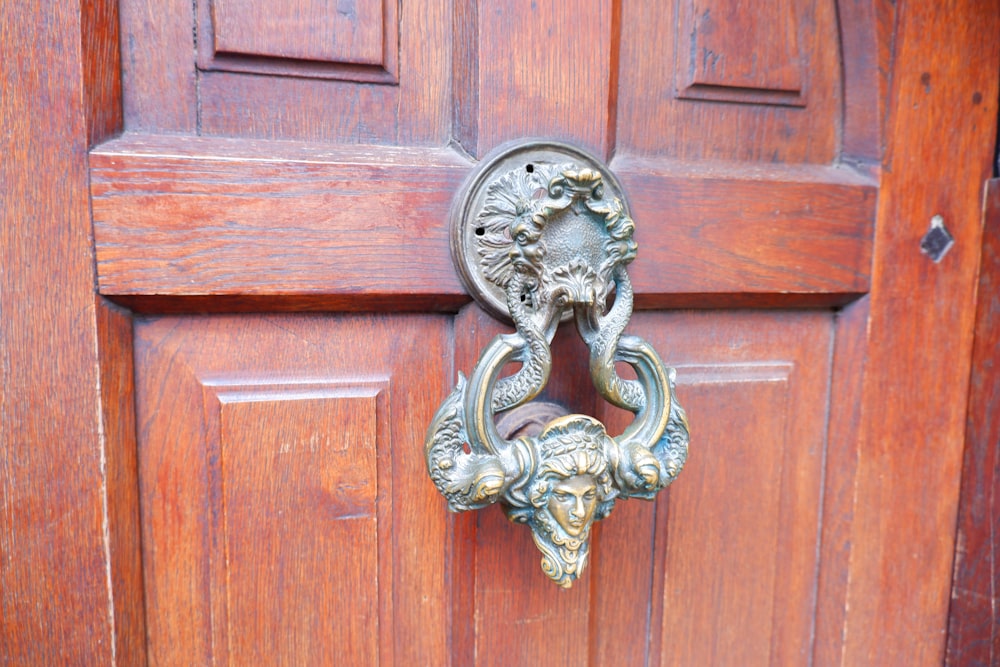 a close up of a door handle on a wooden door