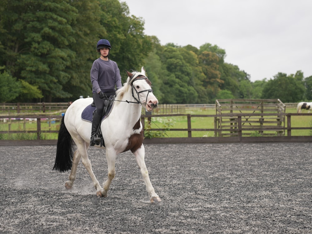 a man riding on the back of a white horse