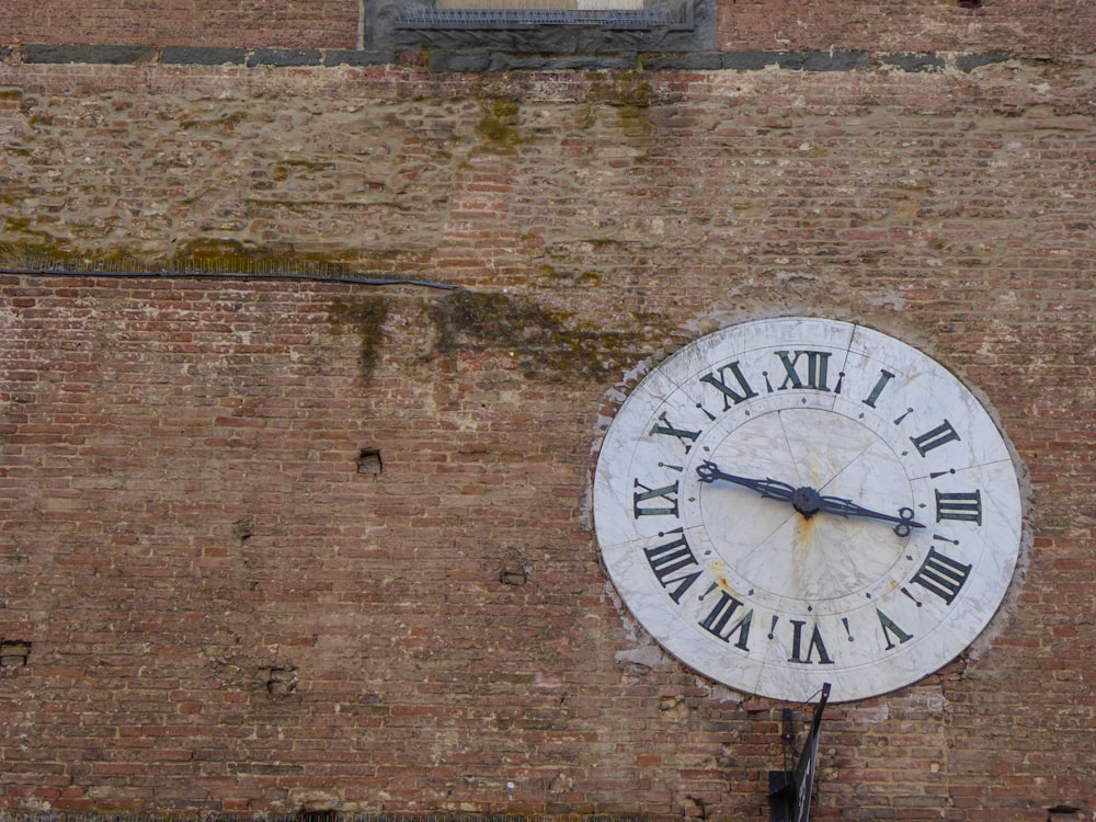 a large clock on the side of a brick building