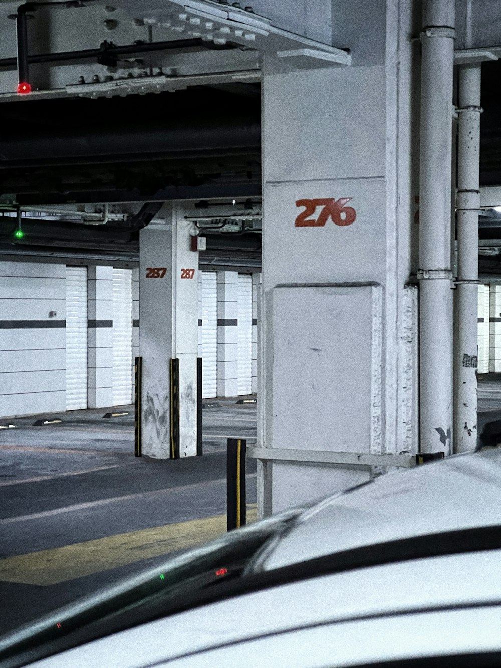 a parking garage filled with lots of white garage doors
