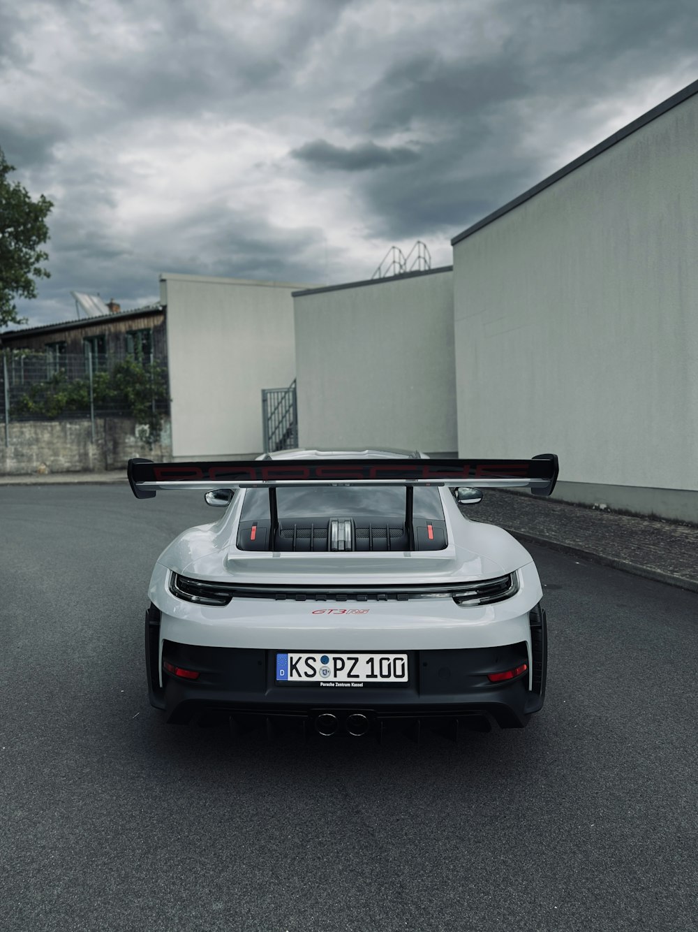 a white sports car parked on the side of a road