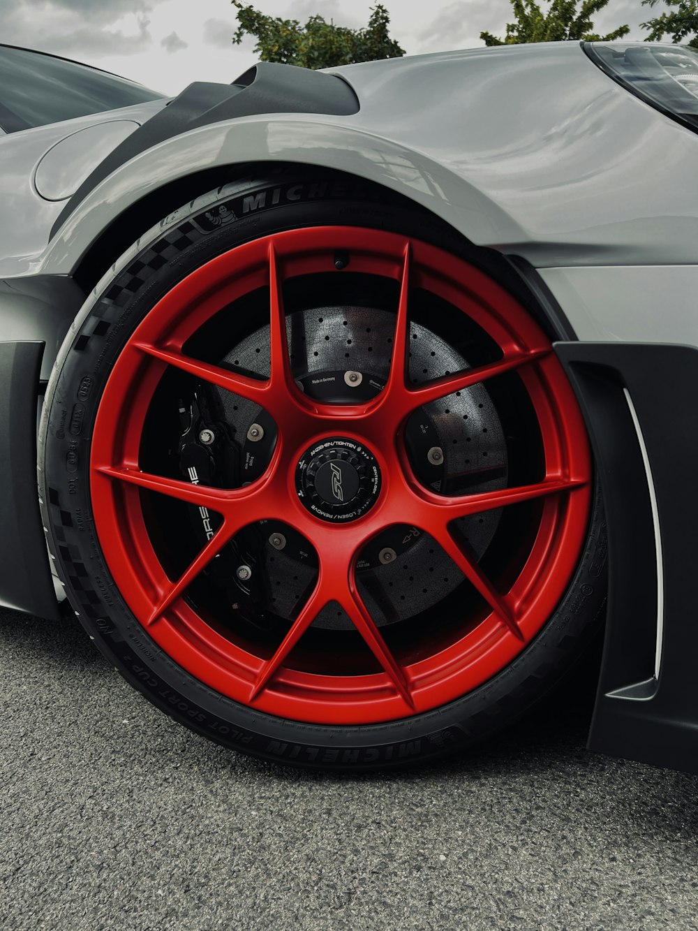 a close up of a red wheel on a sports car