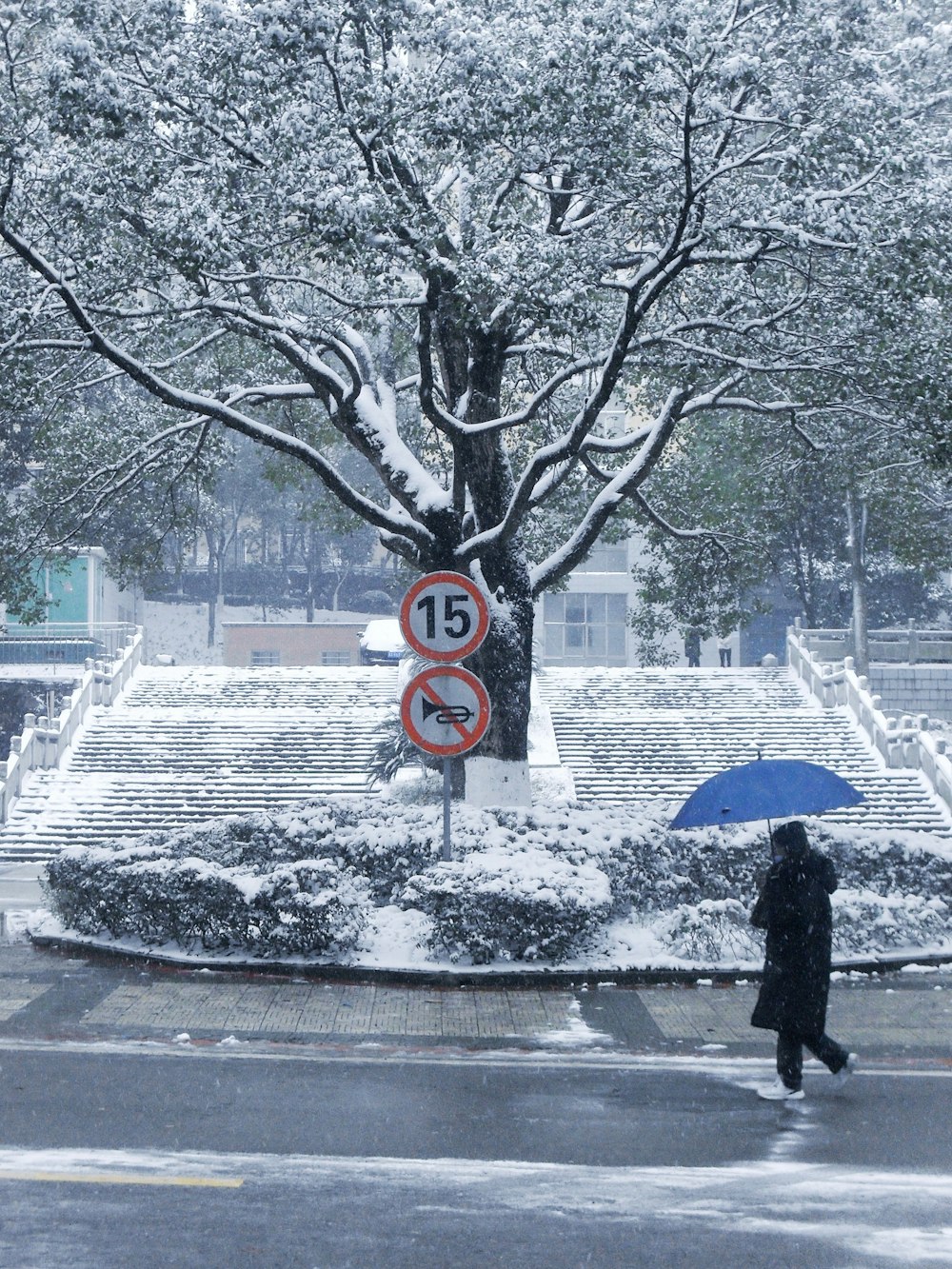 a person walking in the snow with an umbrella