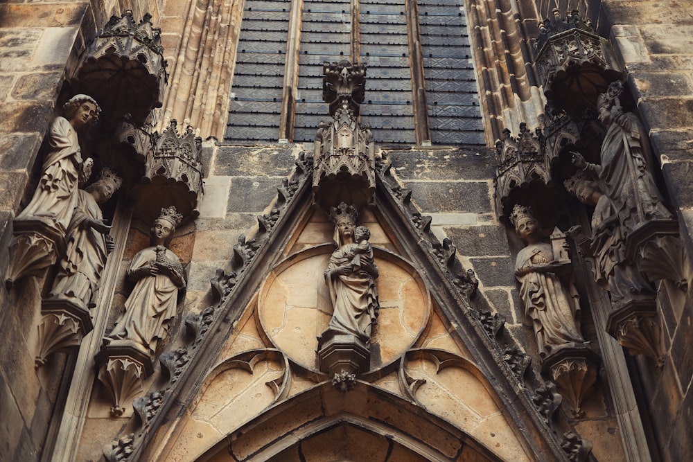 a tall building with statues on the front of it