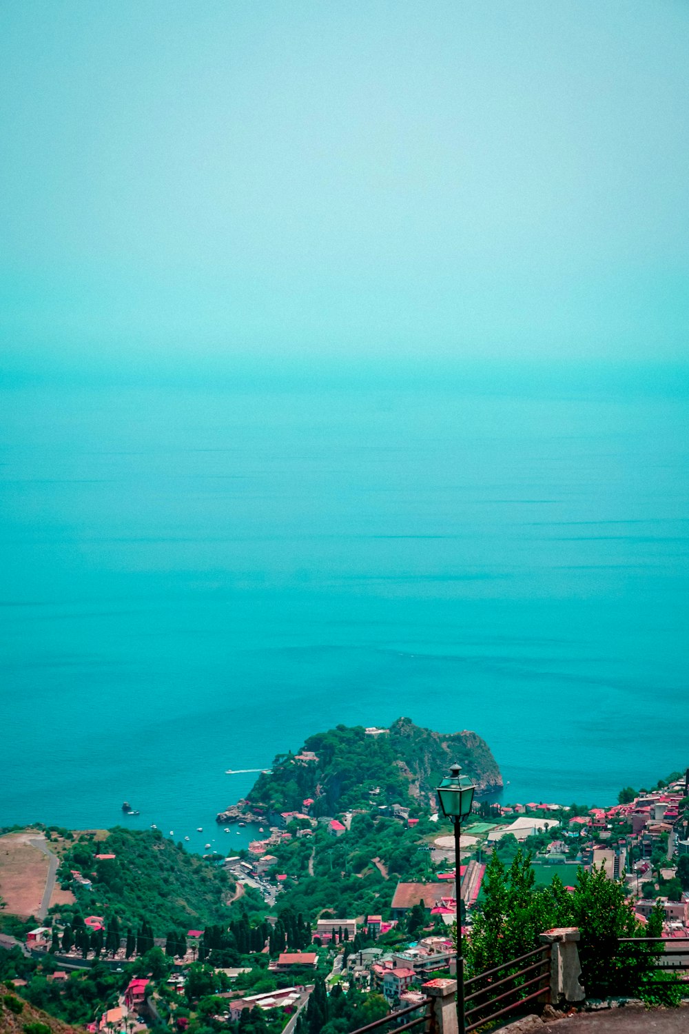 a bench sitting on top of a hill overlooking the ocean