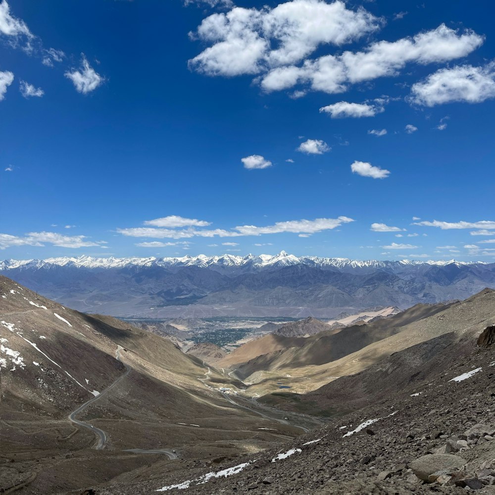 a view of a valley with mountains in the background