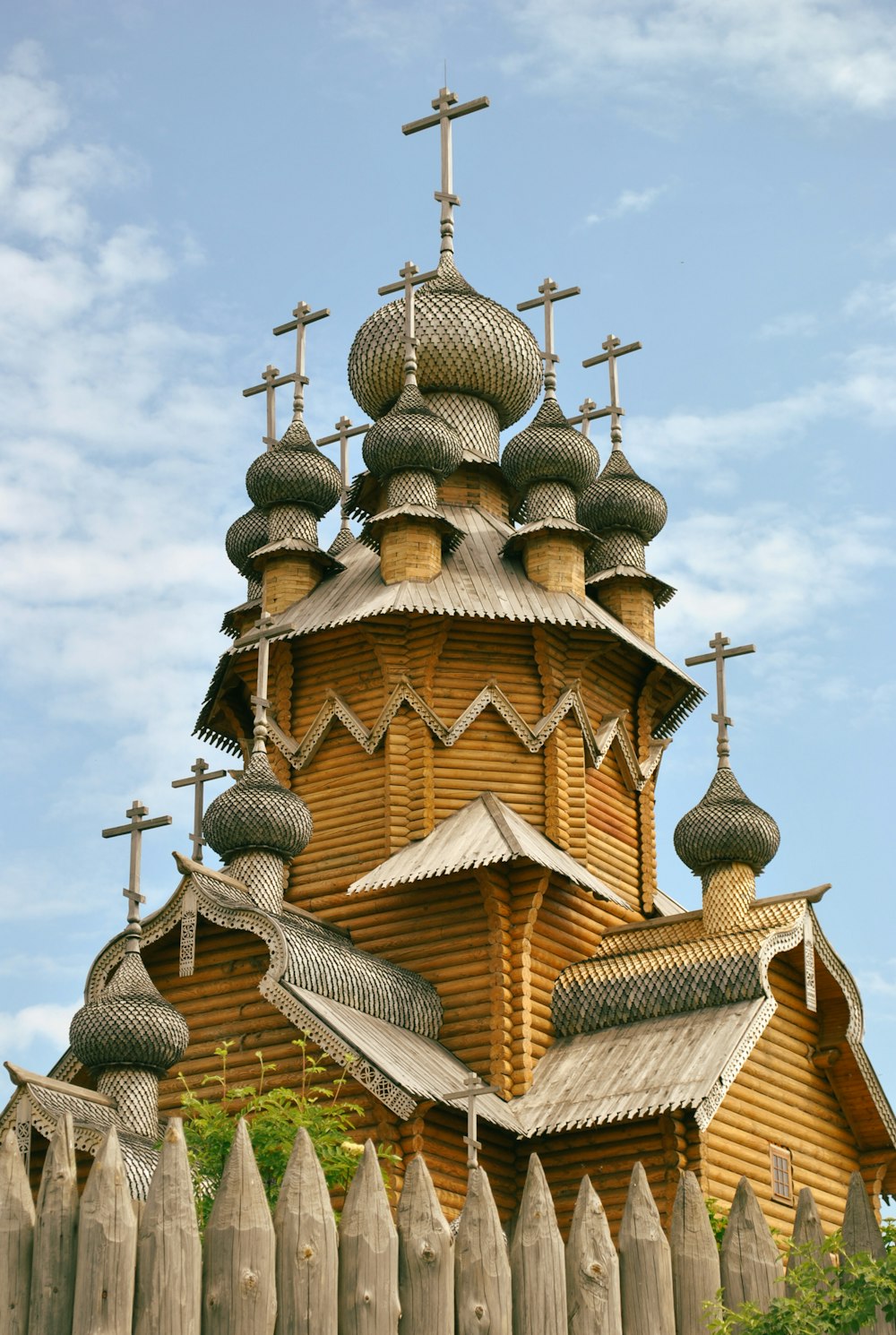 a wooden church with crosses on the roof