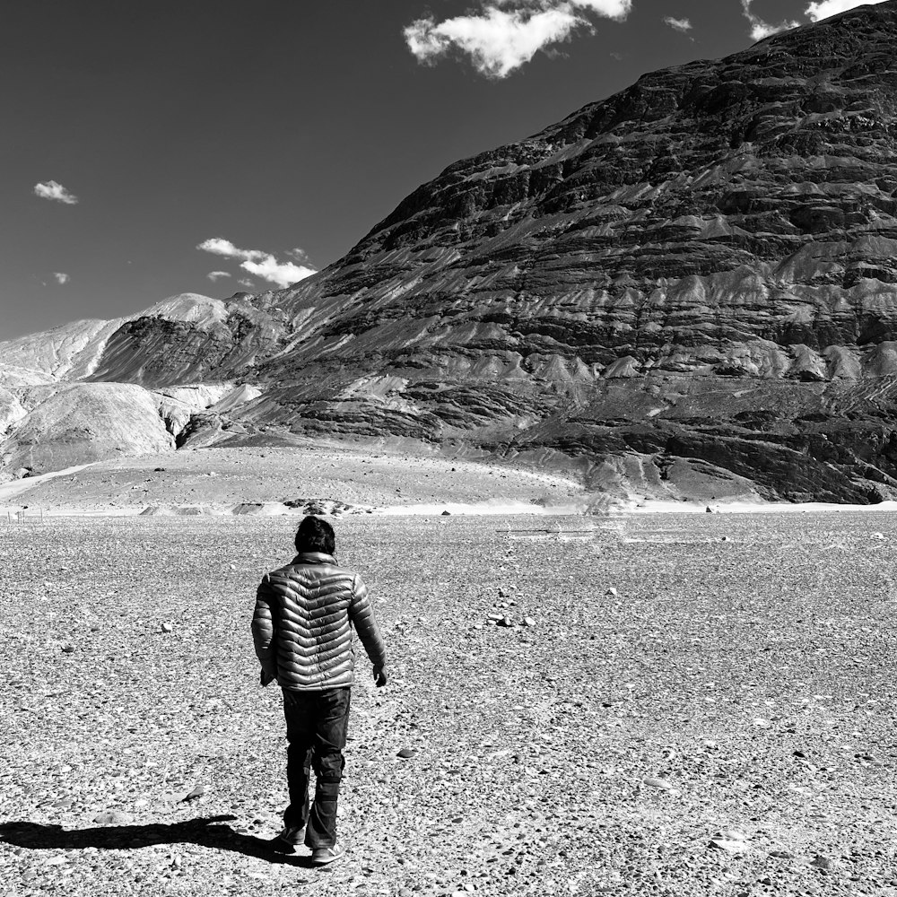 a man standing in the middle of a desert