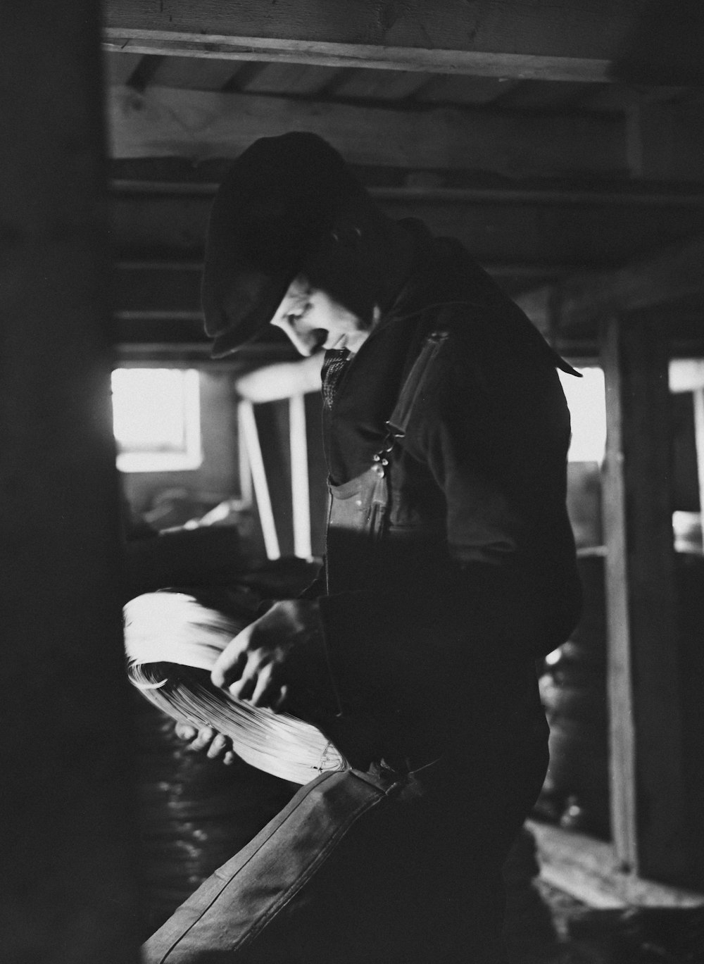 a black and white photo of a man reading a book