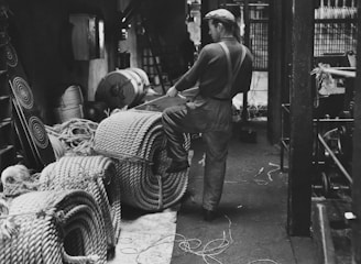 Black and white photo of Grandpa Cees Eras working in his original 1944 furniture workshop.
