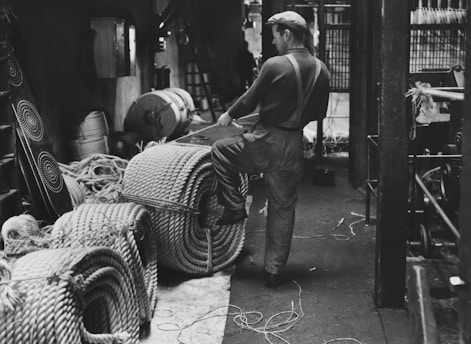 Black and white photo of Grandpa Cees Eras working in his original 1944 furniture workshop.