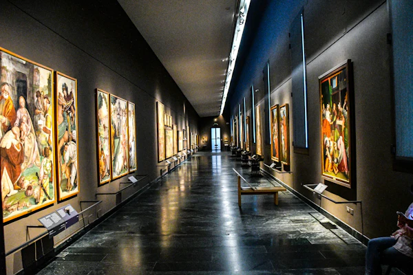 A long gallery corridor hung with student paintings