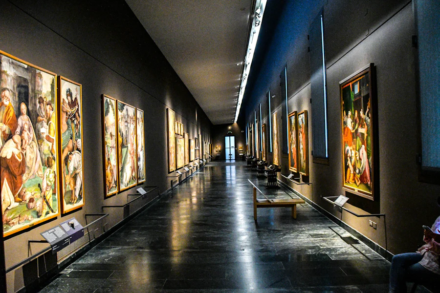 A long gallery corridor hung with student paintings