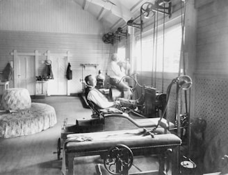 a black and white photo of a man working on a machine