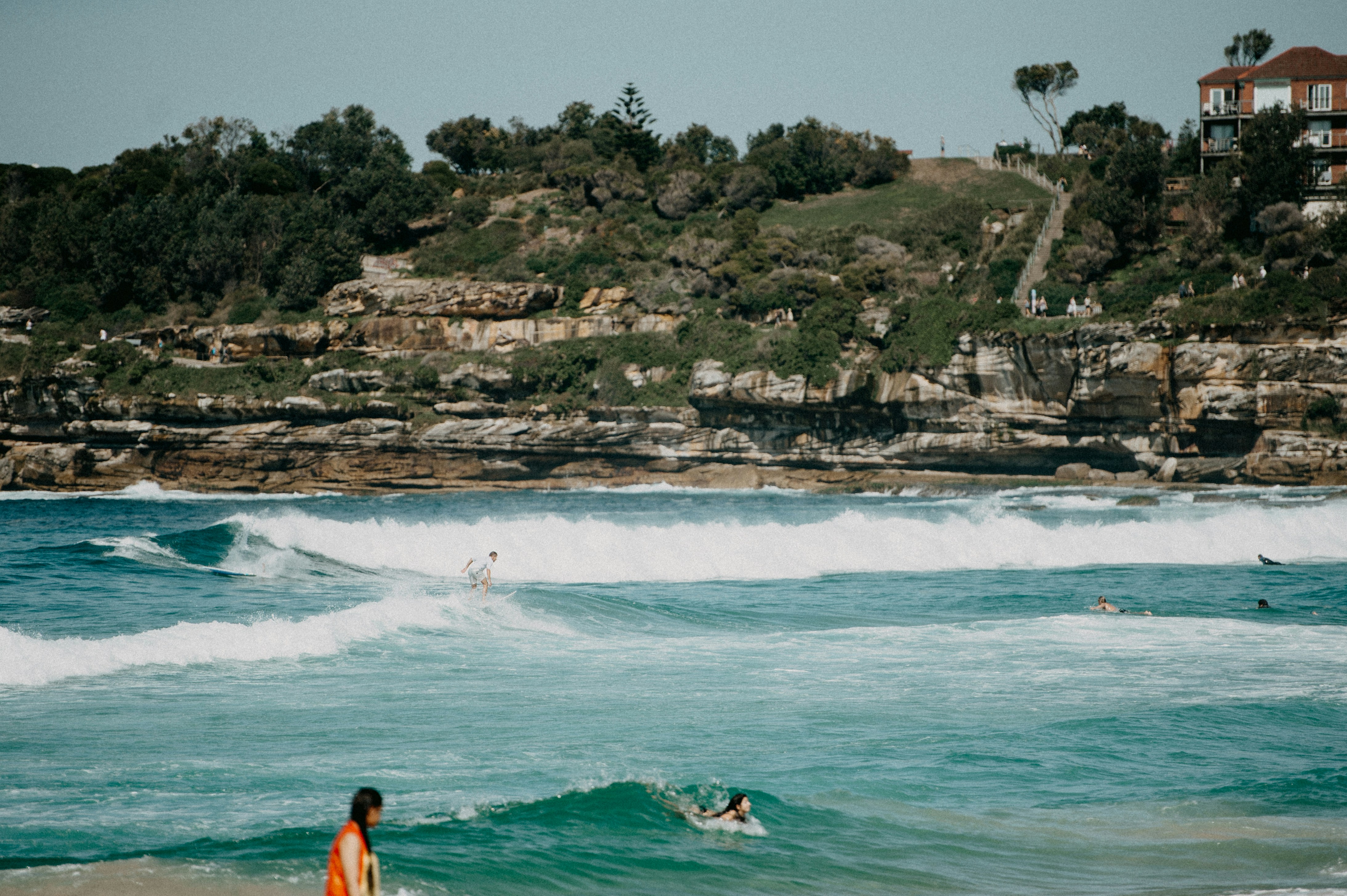a woman is standing on a surfboard in the water