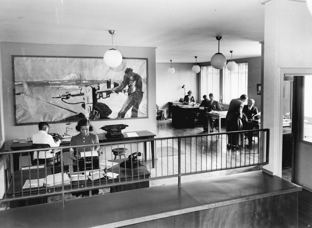 a black and white photo of people in a room