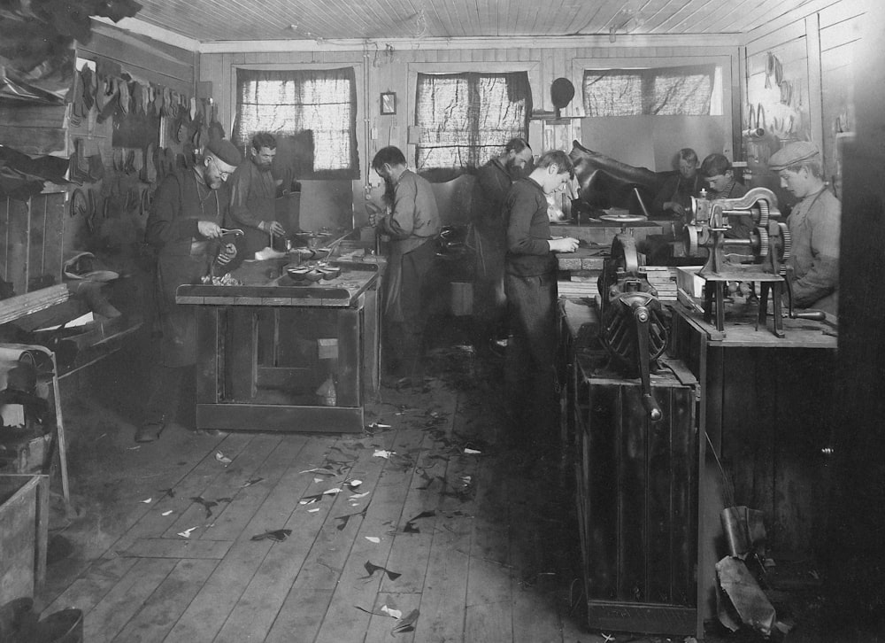 a black and white photo of people in a room